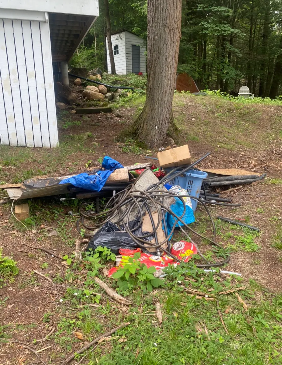 Cottage yard debris pile before removal